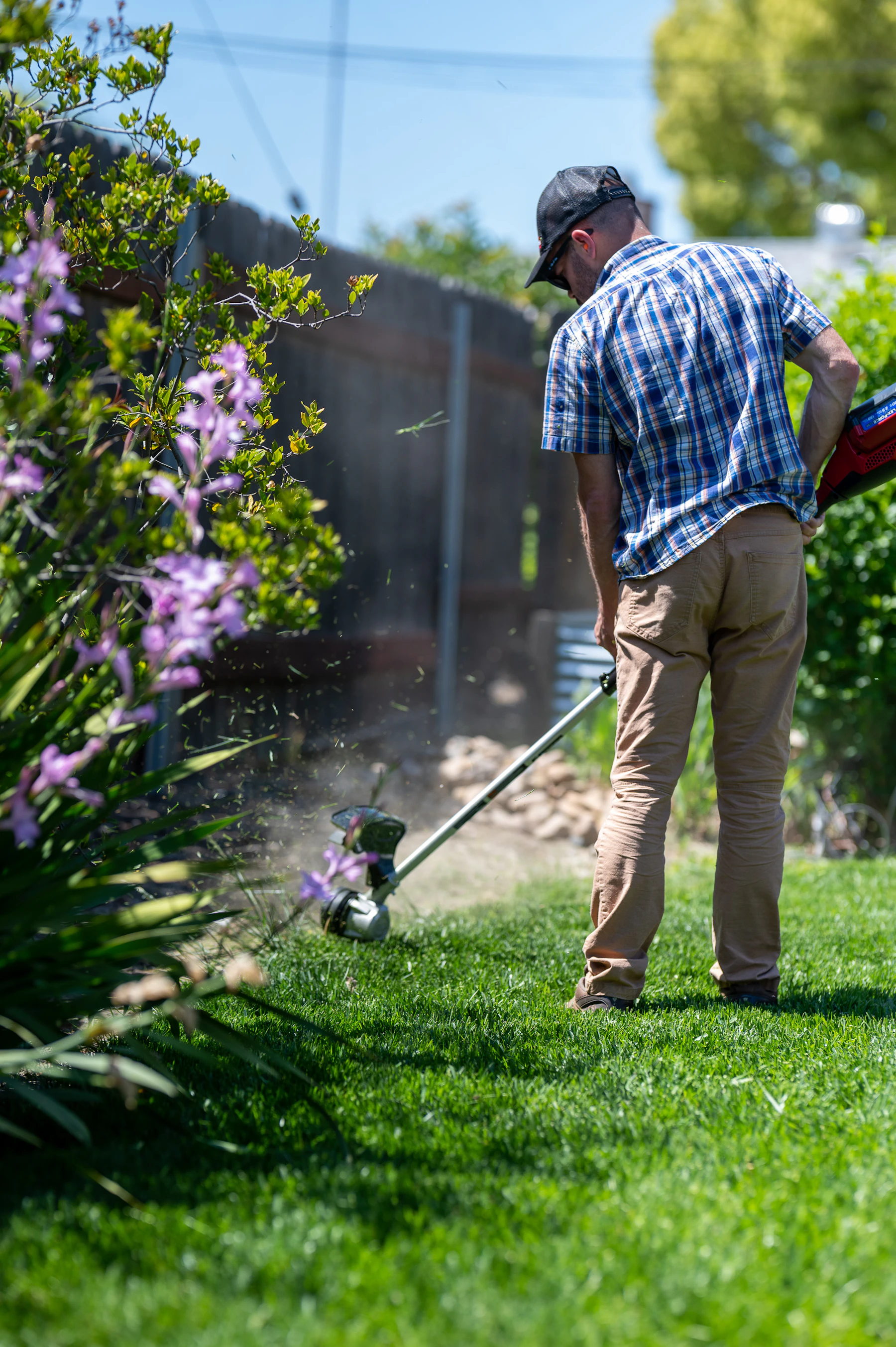 Landscaping professional carefully edging a green lawn